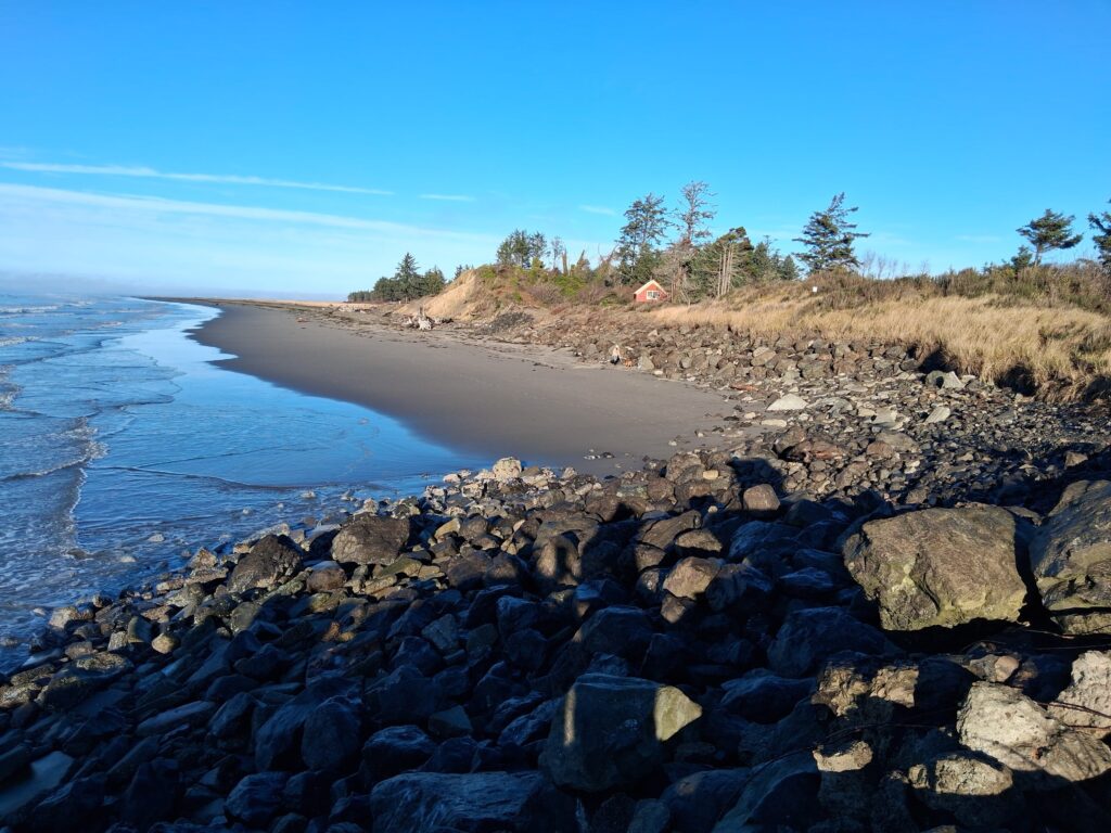 a rocky beach with a body of water in the background (MyCoast AI)