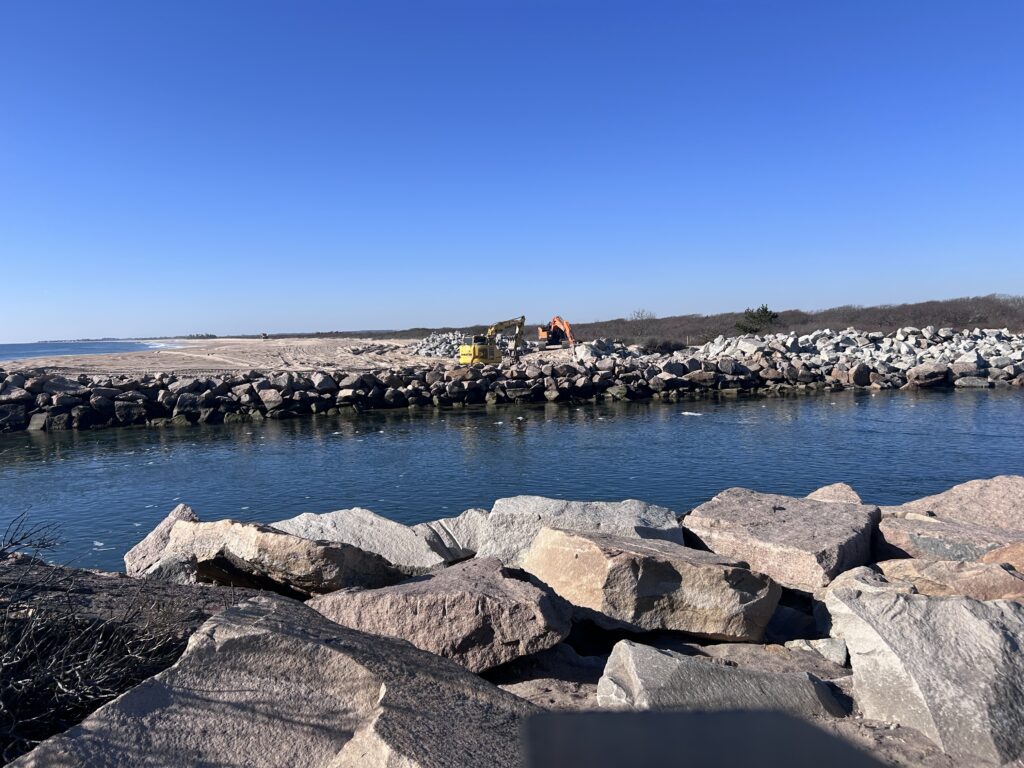 a rocky beach with a body of water in the background (MyCoast AI)