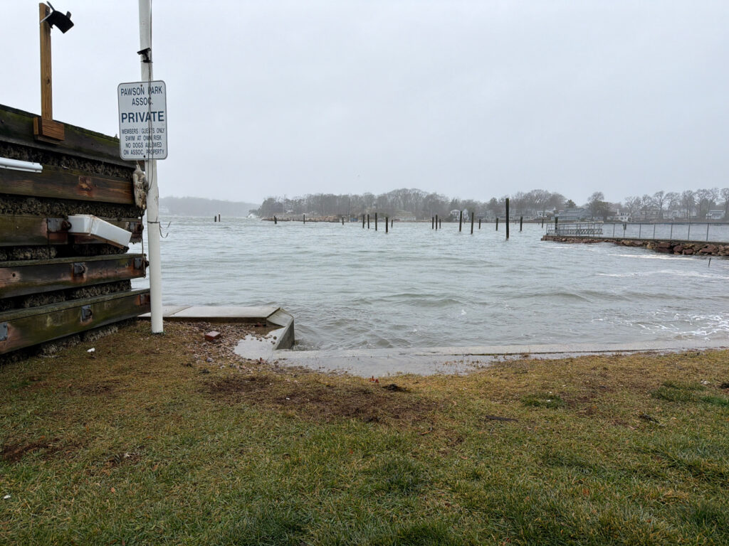 a body of water with a dock and a sign on it (MyCoast AI)