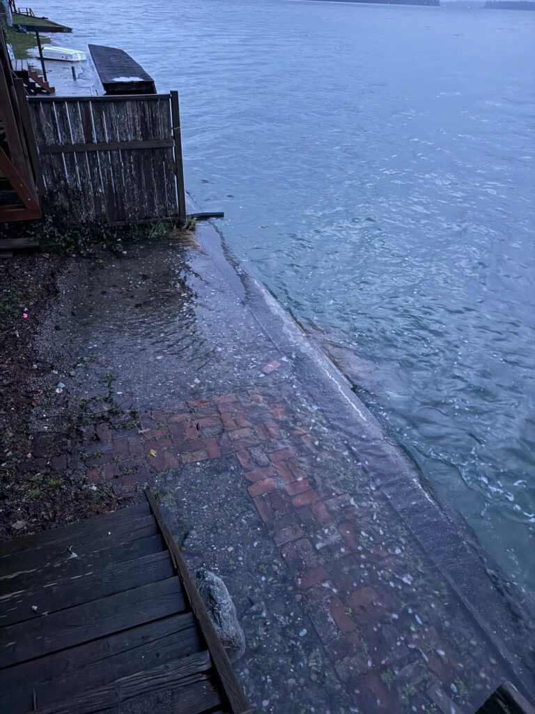 a brick walkway next to a body of water (MyCoast AI)