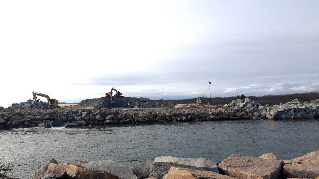 a rocky beach with a body of water and a person on a bicycle (MyCoast AI)
