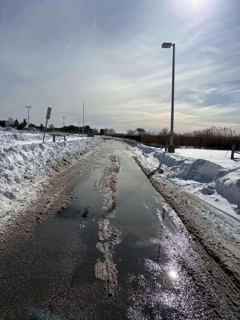 a frozen stream with snow on the sides (MyCoast AI)