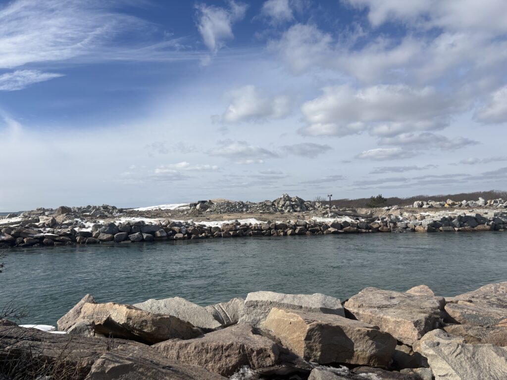 a rocky beach with a body of water in the background (MyCoast AI)