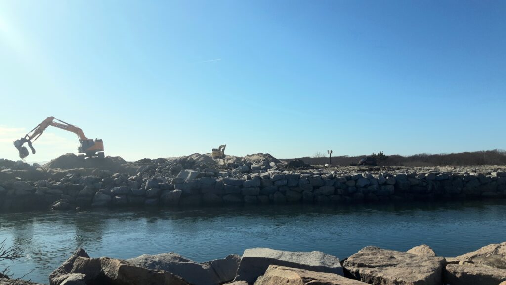 a body of water with rocks and a building in the background (MyCoast AI)