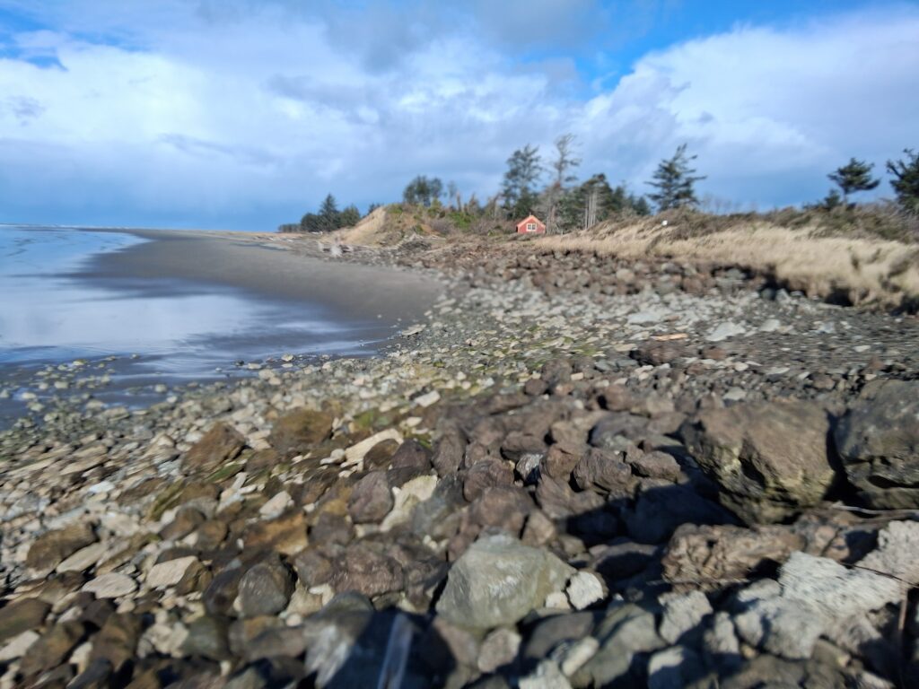 a rocky beach with a red tent (MyCoast AI)