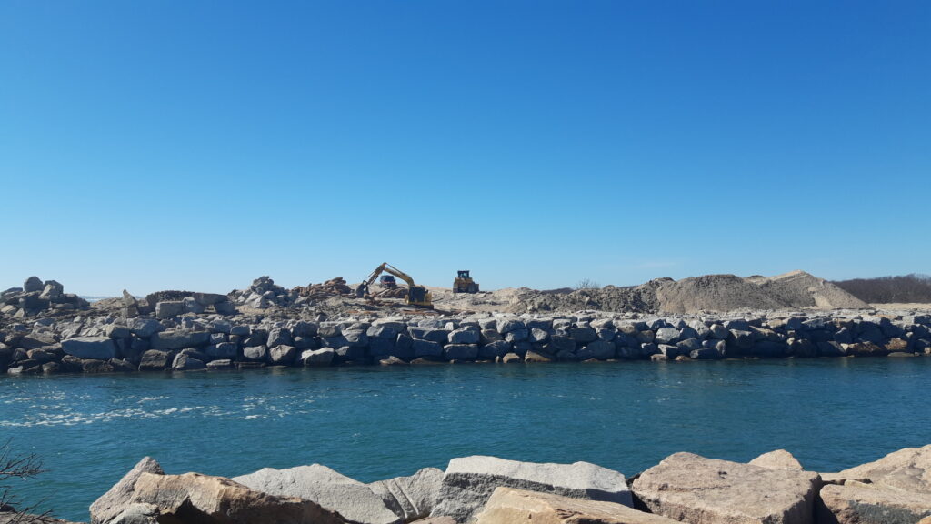 a rocky beach with a house on the shore (MyCoast AI)