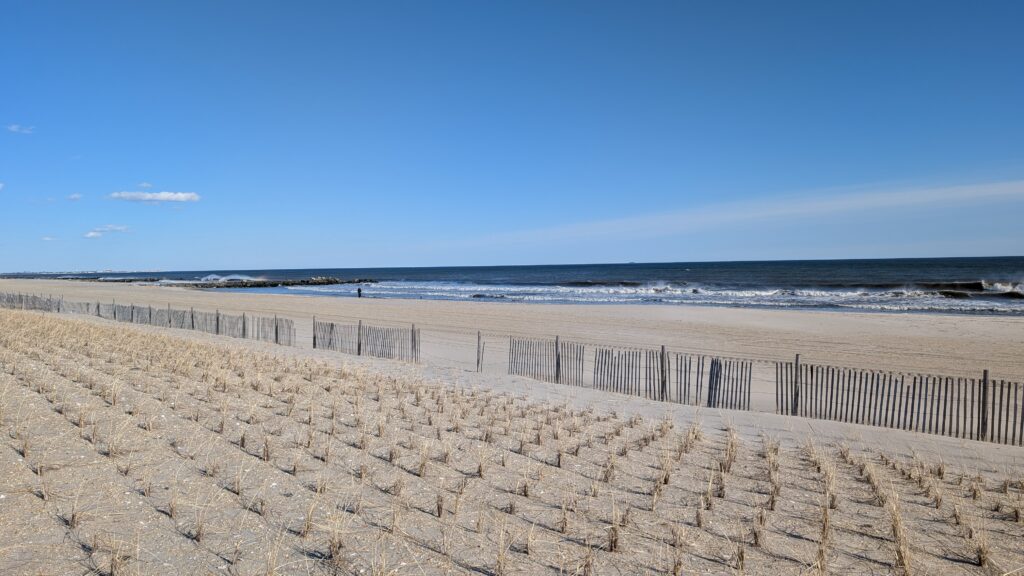 a sandy beach with a fence (MyCoast AI)