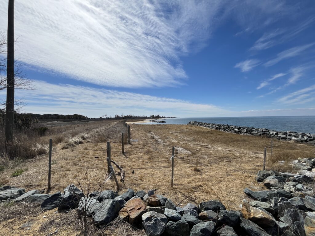 a rocky beach with a fence (MyCoast AI)