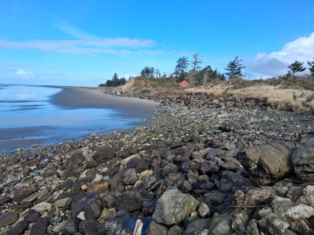 a rocky beach with a small house (MyCoast AI)
