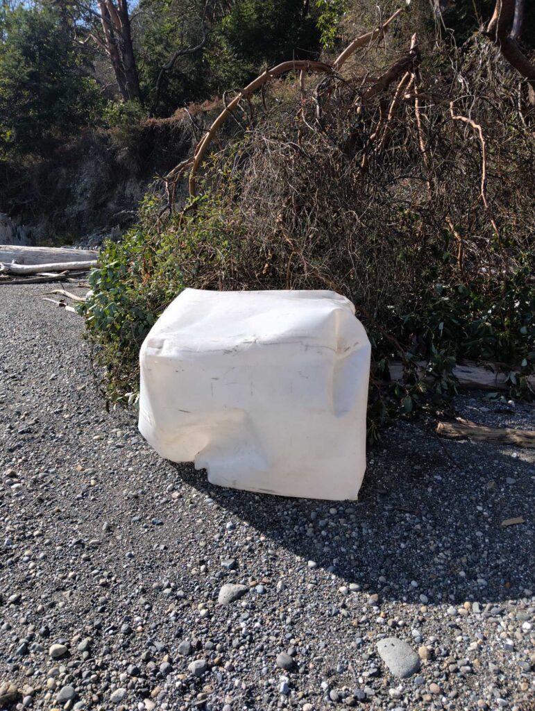 a white container on gravel (MyCoast AI)