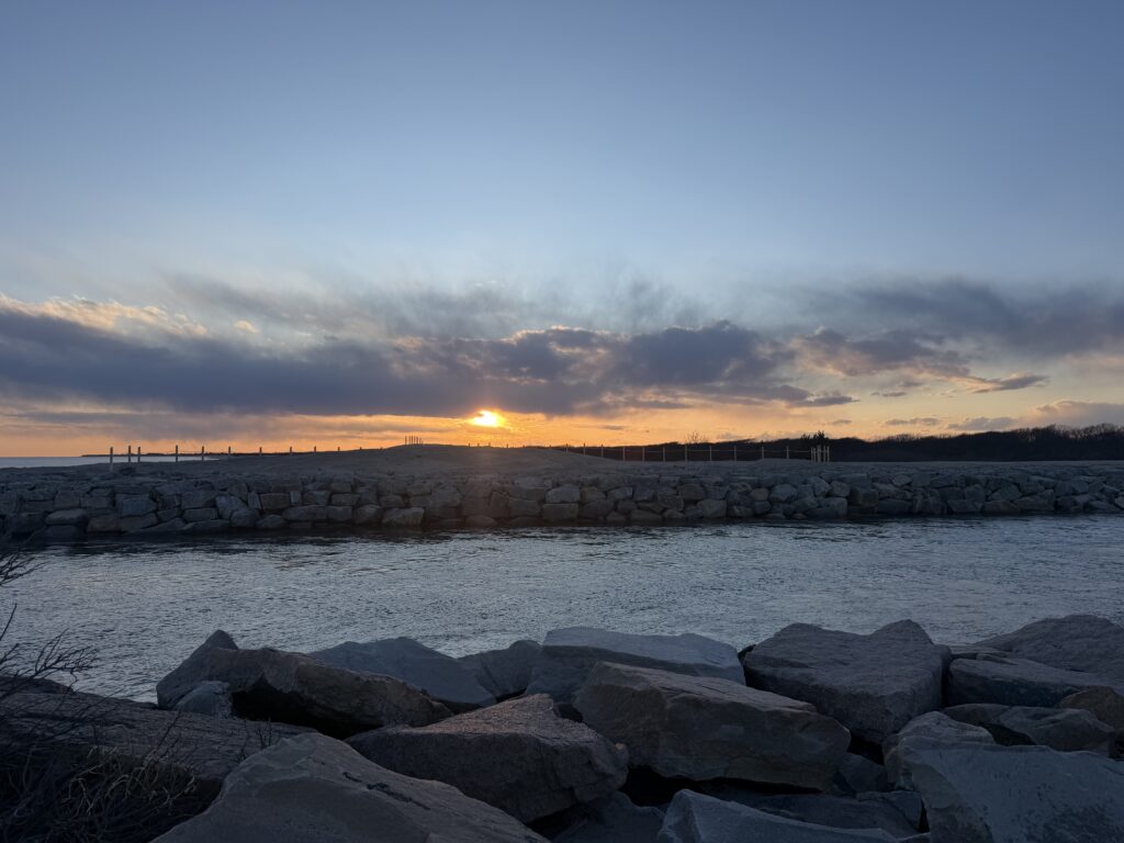 a rocky beach with the sun setting (MyCoast AI)