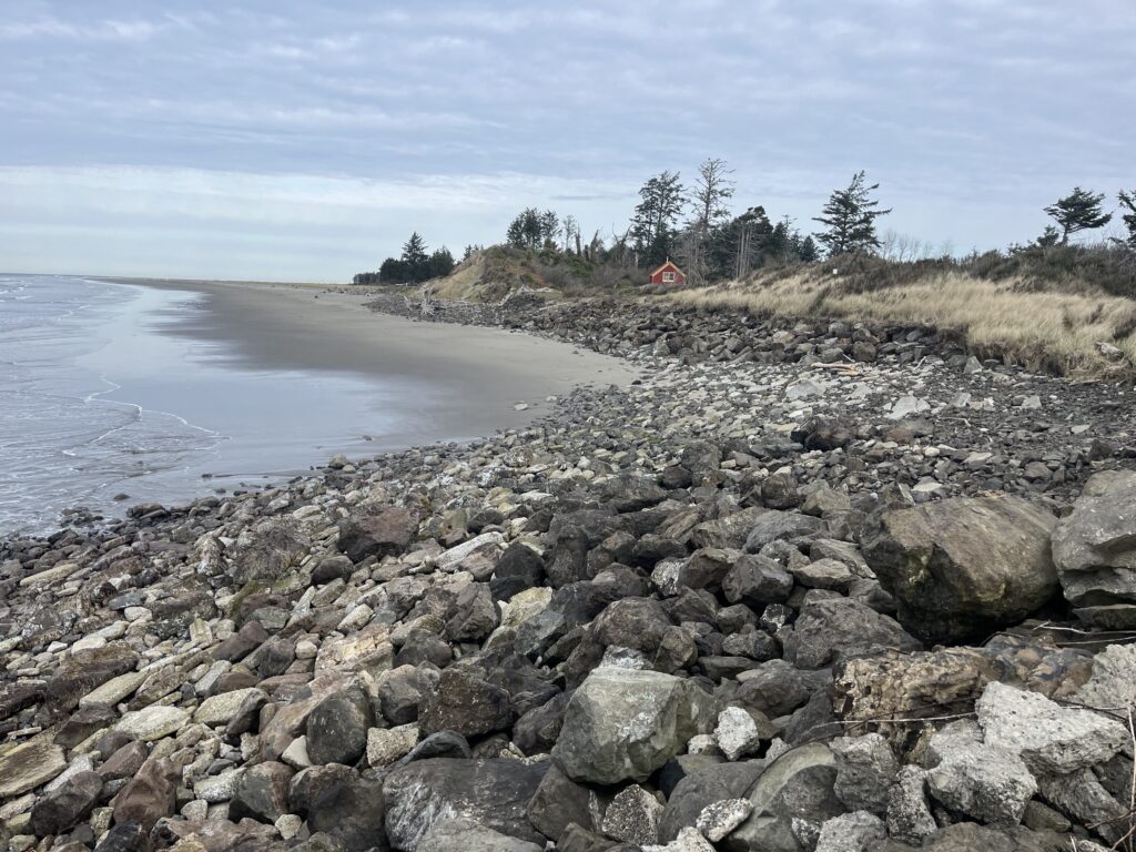 a rocky beach with a small house (MyCoast AI)