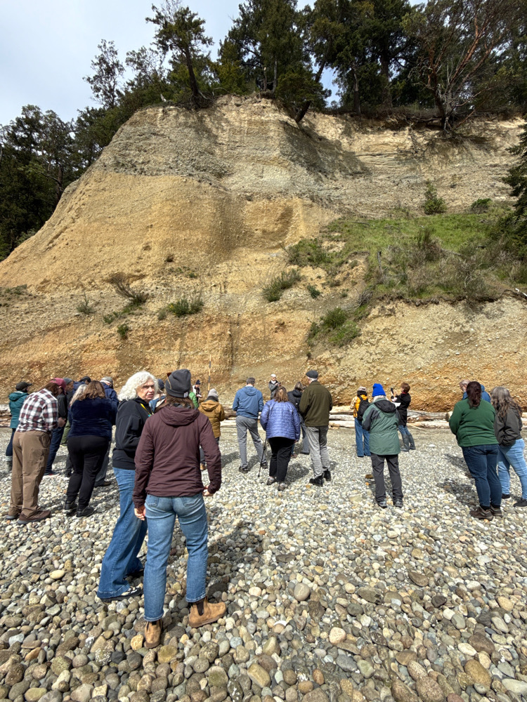 a group of people standing on a rocky area (MyCoast AI)