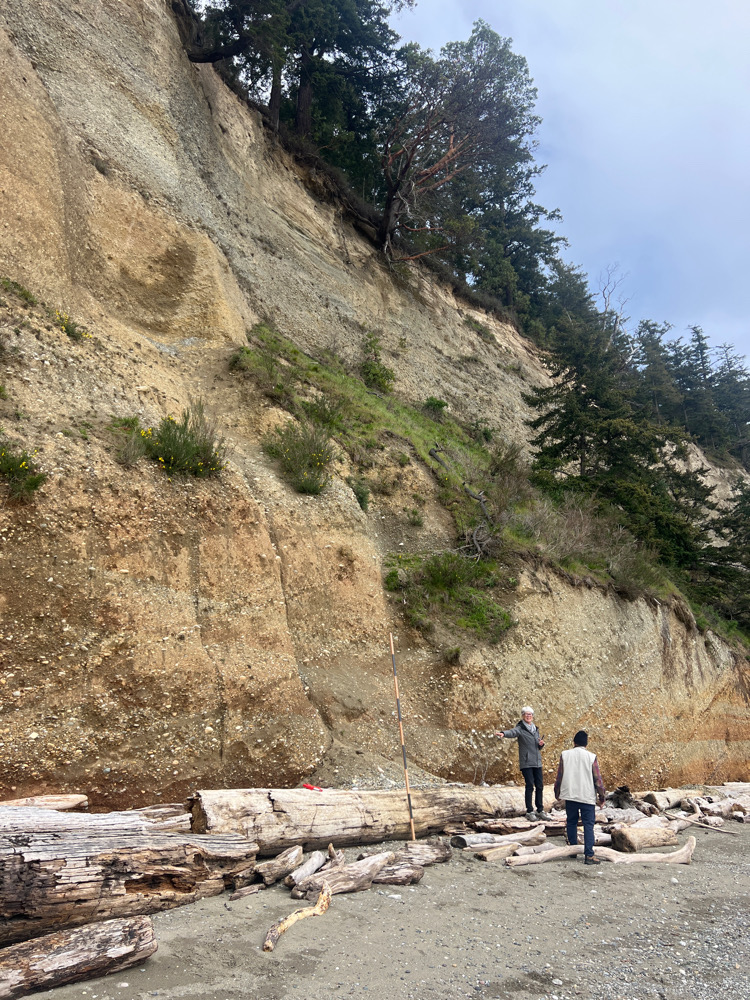 a couple of people standing on a rocky hillside (MyCoast AI)
