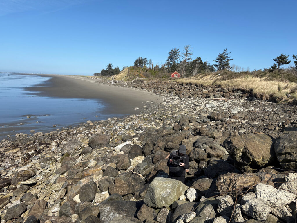 a person sitting on a rocky beach (MyCoast AI)