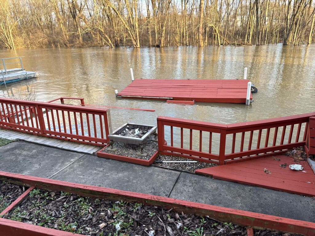 a group of red benches next to a body of water (MyCoast AI)