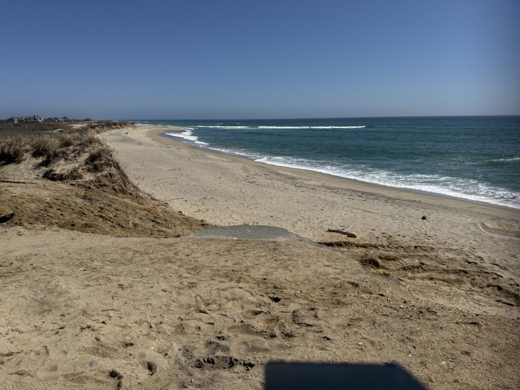 a sandy beach with waves crashing on it (MyCoast AI)
