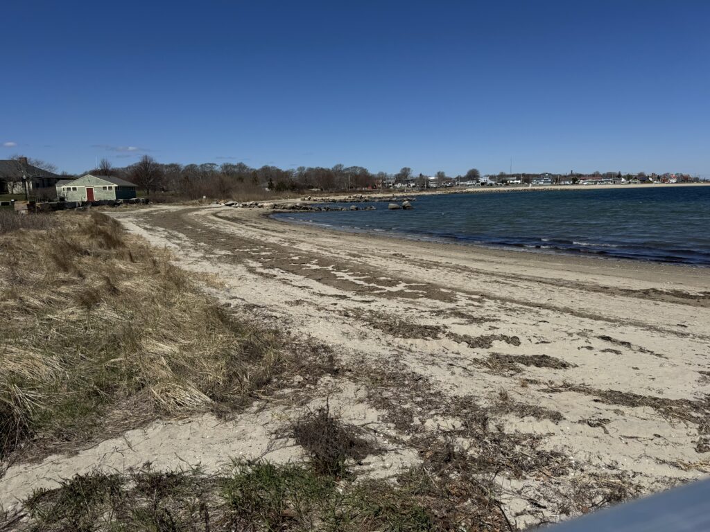 a sandy beach with a building in the distance (MyCoast AI)