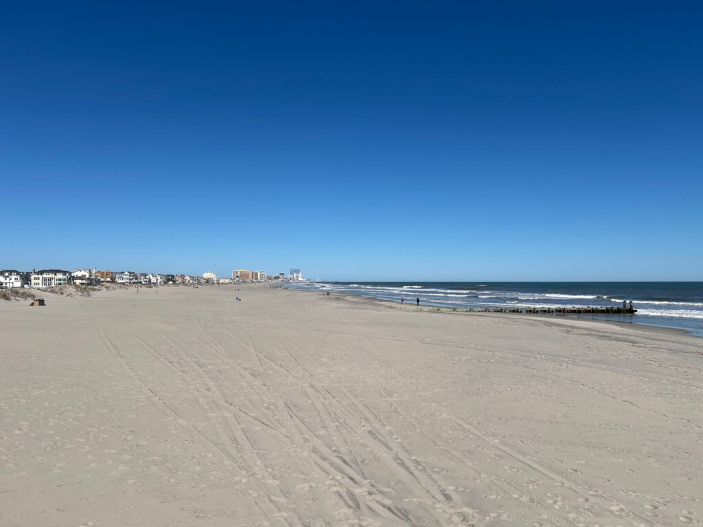 a sandy beach with waves crashing on it (MyCoast AI)