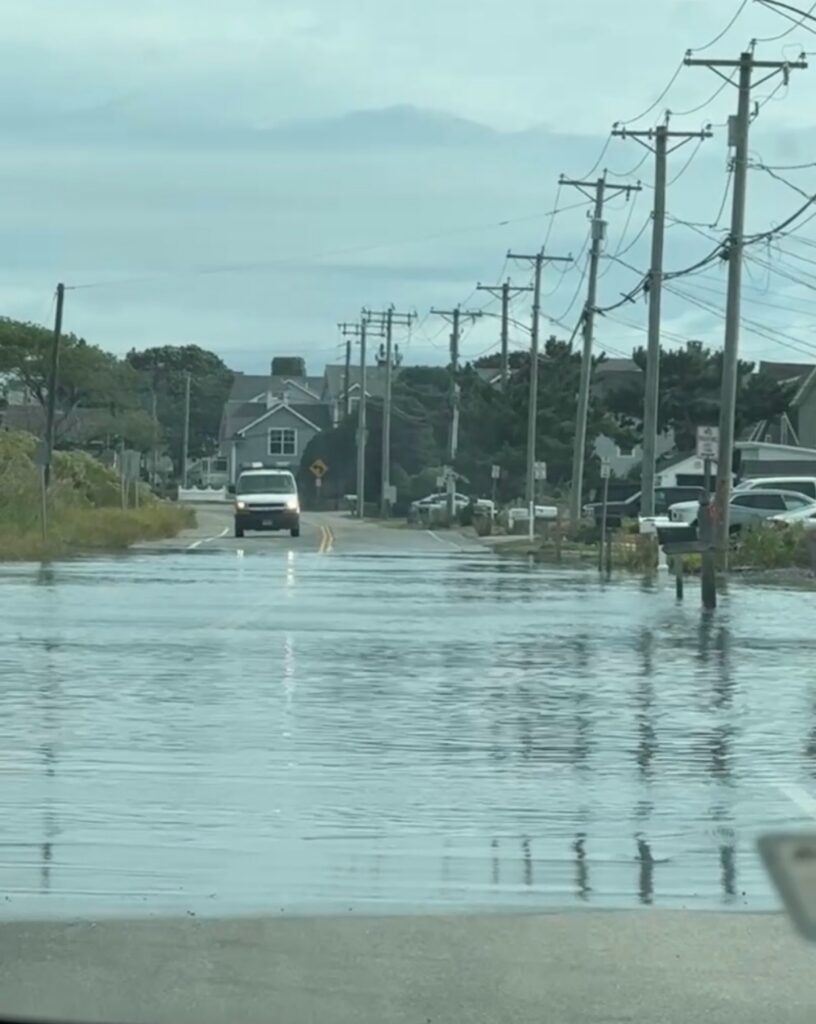a flooded street with cars and houses (MyCoast AI)