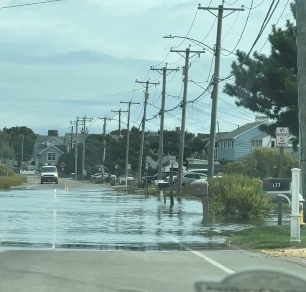 a flooded street with cars and houses (MyCoast AI)