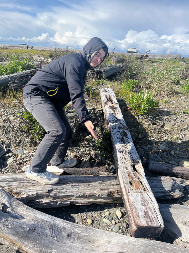 a man wearing a helmet and standing on a log (MyCoast AI)