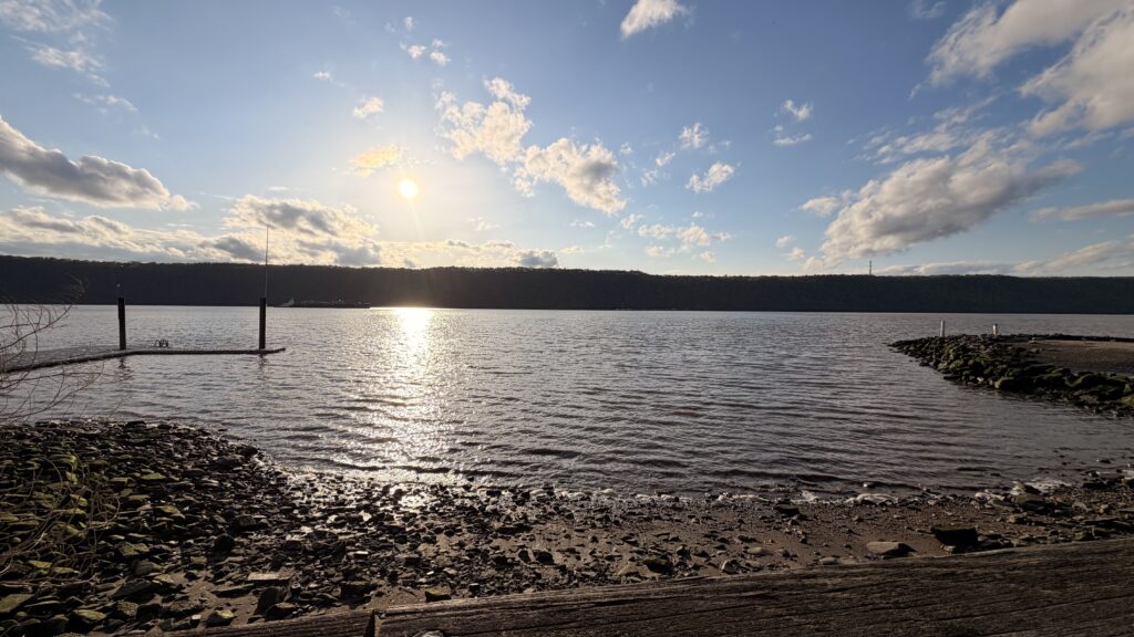 a body of water with a beach and a land with a sunset (MyCoast AI)