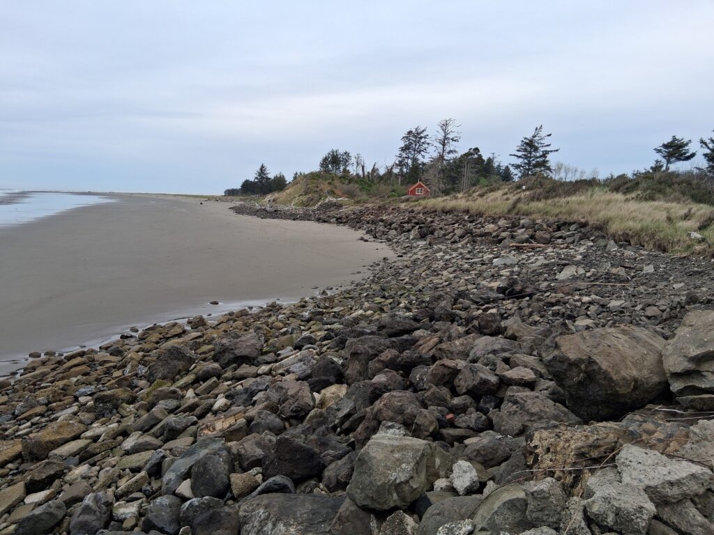 a rocky beach with a small building (MyCoast AI)