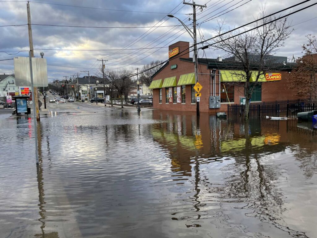 a flooded street with buildings and power lines (MyCoast AI)