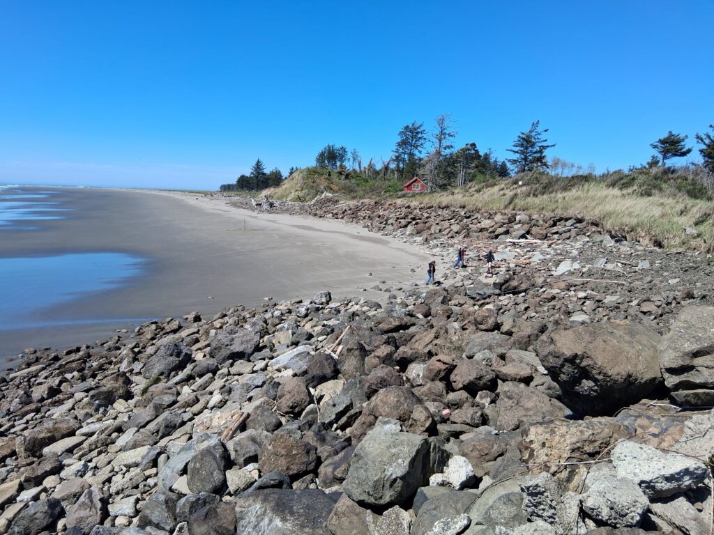 a rocky beach with people walking on it (MyCoast AI)