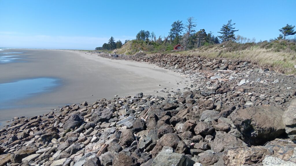 a rocky beach with a red house (MyCoast AI)
