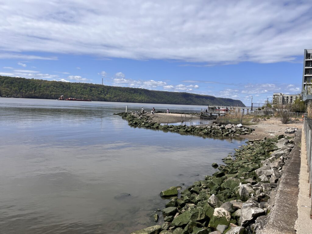 a body of water with rocks and a road by it (MyCoast AI)