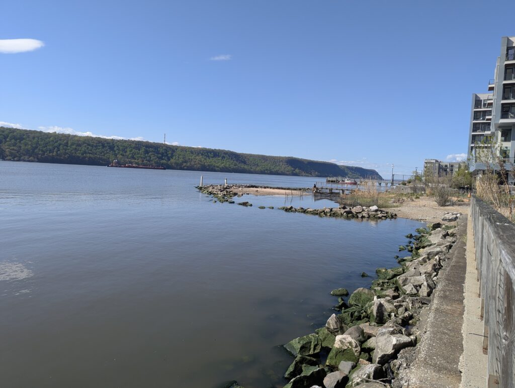 a body of water with rocks and buildings around it (MyCoast AI)