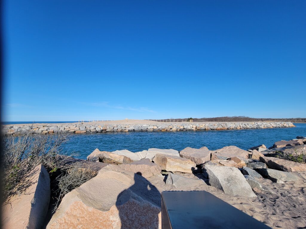 a rocky beach with a body of water in the background (MyCoast AI)