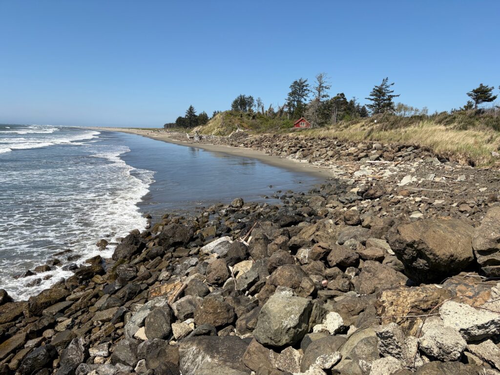 a rocky beach with a red house (MyCoast AI)