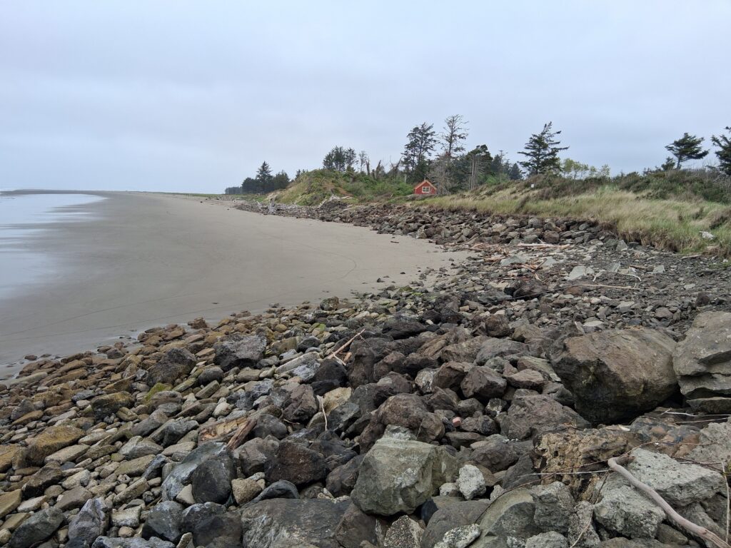 a rocky beach with a tent (MyCoast AI)